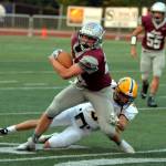RYAN SPARKS | THE DAILY WORLD Montesano receiver Tyler Johansen, foreground, attempts to escape the tackle of Aberdeen defender Kyle Miller (5) during the Bulldogs 29-0 win on Friday in Montesano.
