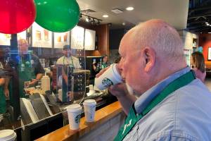 Michael S. Lockett / The Daily World 
Aberdeen Mayor Pete Schave judges a latte-making competition at Badges & Brews, hosted at Starbucks.