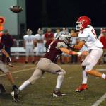 RYAN SPARKS | THE DAILY WORLD 
Montesano linebacker Gabe Pyhala, middle, pressures Castle Rock quarterback Stephen Ibsen during the Bulldogs 57-12 victory over Castle Rock on Friday in Montesano.