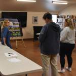 Amanda Fleischman, landscape designer, left, and Amber Mikluscak, landscape architect, second from left, both of The Watershed Company, talk with Scott Anderson, Ocean Shores City Administrator, second from right, at the Ocean Shores Library on Friday afternoon, Sept. 23. (Clayton Franke | The Daily World)