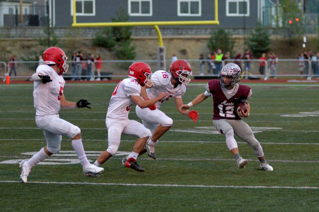 DAILY WORLD FILE PHOTO Montesanos Cole Ekerson (12) is chased by Castle Rock defenders in a win on Friday, Sept. 23, 2022 in Montesano. The Bulldogs will have a tough road test when they take on the Shelton Highclimbers on Friday.
