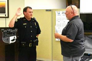 Matthew N. Wells | The Daily World 
Aberdeen Police Department Chief Dale Green swears in with Aberdeen Mayor Pete Schave on Wednesday night, Sept. 28, at the Aberdeen City Council meeting in the council chambers. Green, who was interim chief since now-retired Chief Steve Shumate retired June 30, will start as chief of police on Saturday, Oct. 1.