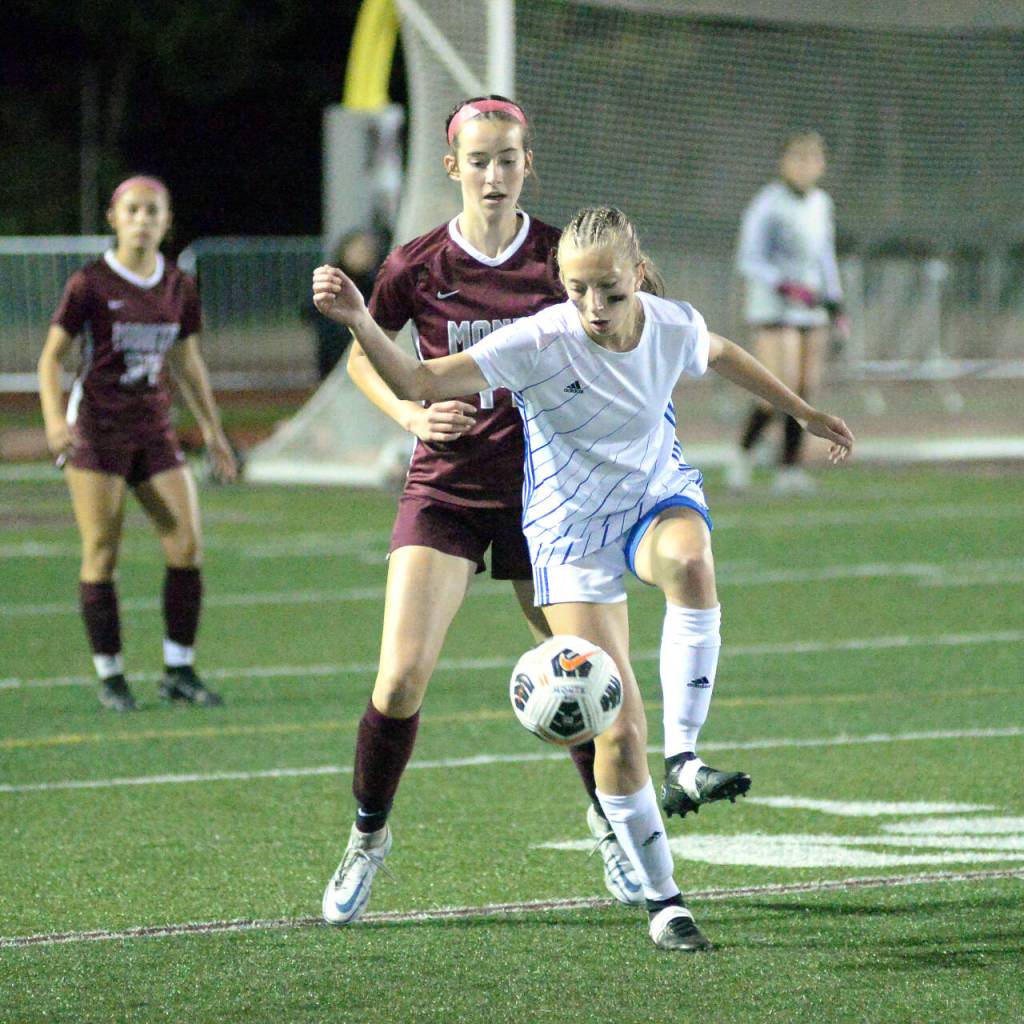 RYAN SPARKS | THE DAILY WORLD Elma forward Beta Valentine collects a throw-in while being defended by Montesano midfielder Ava Schrader during the Bulldogs 2-1 win on Tuesday in Montesano.