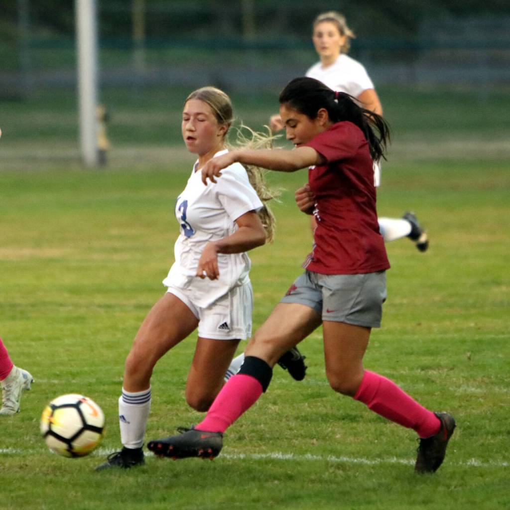 PHOTO BY BEN WINKELMAN Hoquiams Yazmin Garcia-Lopez, right, dribbles against Eatonvilles Haley Courson during the Grizzlies shootout loss on Tuesday at Olympic Stadium in Hoquiam.