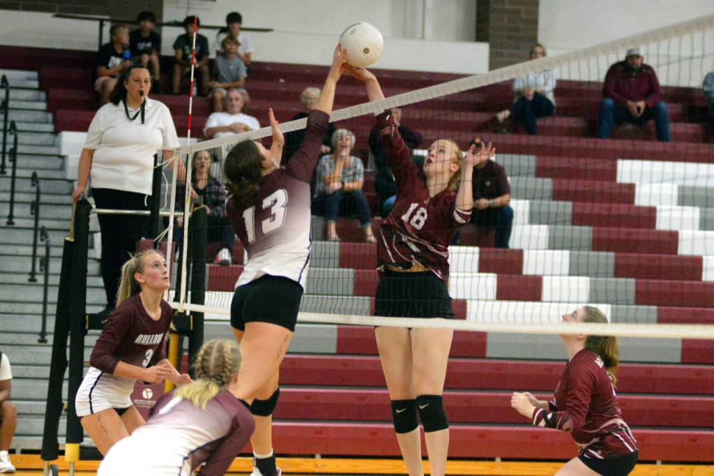 RYAN SPARKS | THE DAILY WORLD Ocosta senior Alexandria Matthews (18) and Montesanos Addie Winter (13) meet at net during the Bulldogs 3-0 win in a non-league match on Wednesday in Montesano.