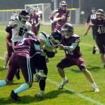 RYAN SPARKS | THE DAILY WORLD Hoquiam defenders Owen McNeill (3) and Zander Jump (10) tackle Tenino quarterback Cody Strawn during the Grizzlies 50-14 loss on Friday, Oct. 7, 2022 at Olympic Stadium in Hoquiam.