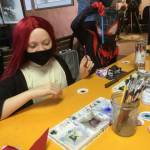 A participant paints eyeballs for pumpkins at the Cosi Art Center.