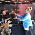 Amee Weasa of Tokeland Candle Works, left, sells some candles to Donya Haas, a vendor selling Pussycat Cupcakes on Sunday at Graylands Cranberry Fest.