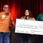 Matthew N. Wells | The Daily World
Bill Mullikin, left, program manager for The Walkthrough  a homeless youth shelter program  stands with Lucy Machowek, chief financial officer at Coastal Community Action Program. The duo holds a novelty-sized check showing $11,800 that 100+ Harbor Women Who Care initially raised Tuesday night inside Hoquiam Elks Lodge 1082. Maryann Welch, who leads the Grays Harbor chapter of the 100+ Women Who Care, stands to the right of the happy pair. As of Wednesday, once the final count was done, $14,200 in total was raised for the shelter. (Matthew N. Wells | The Daily World)