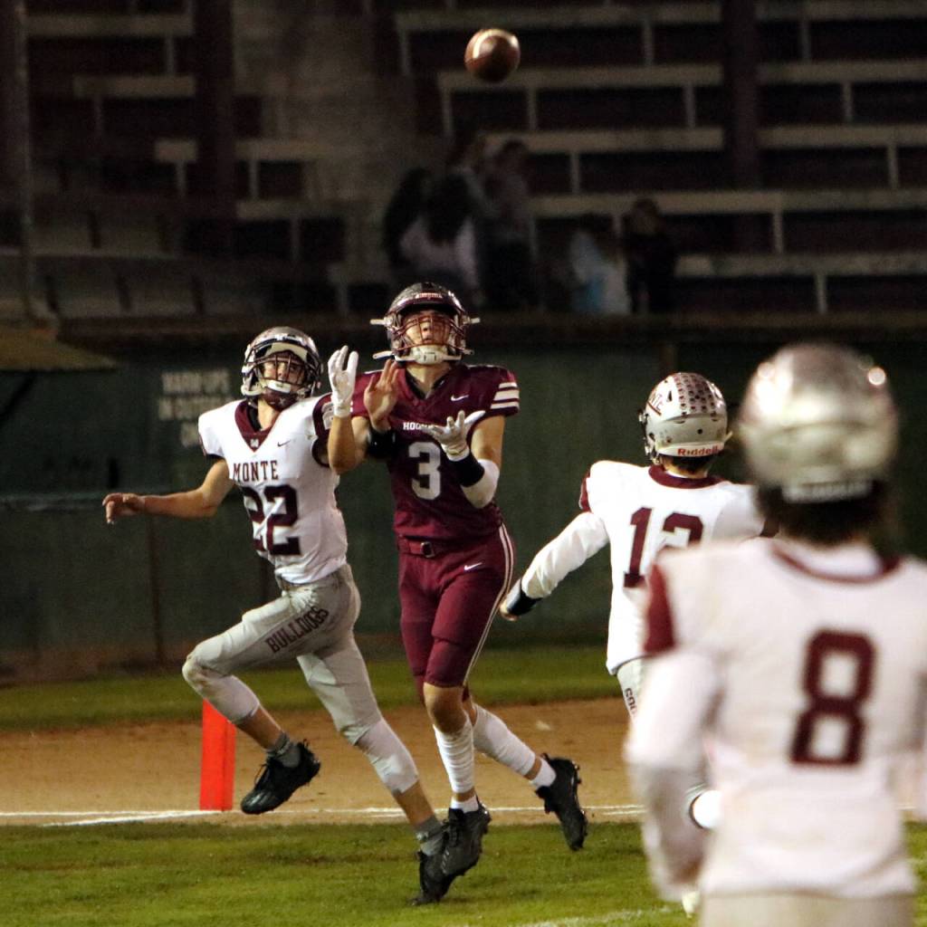PHOTO BY BEN WINKELMAN Hoquiam senior receiver Owen McNeill (3) makes a touchdown catch while being defended by Montesanos Bode Poler (22) during the Bulldogs 47-6 victory on Friday at Olympic Stadium in Hoquiam.