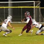 PHOTO BY BEN WINKELMAN Hoquiam running back Jake Templer (18) is pursued by Montesano defenders Mateo Sanchez (52) and Tyler Johansen (24) during the Bulldogs 47-6 victory on Friday at Olympic Stadium in Hoquiam.