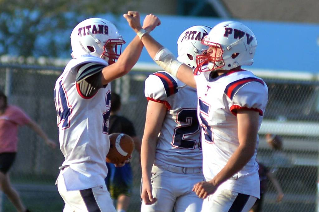 RYAN SPARKS | THE DAILY WORLD Pe Ell-Willapa Valley running back Derek Fluke (24) is congratulated by teammate Wil Clements (5) after scoring a touchdown during a 28-14 win over Raymond-South Bend on Saturday at Millam Field in South Bend.