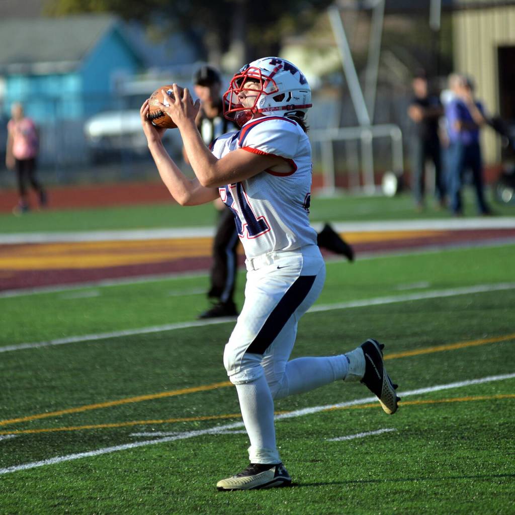 RYAN SPARKS | THE DAILY WORLD Pe Ell-Willapa Valley sophomore split end Kannyon Clements hauls in a touchdown pass from quarterback Kolten Fluke during the Titans 28-14 victory over Raymond-South Bend on Saturday in South Bend.