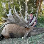 Photo courtesy Brian Dhoogie 
Hoquiam hunter Brian Dhoogie poses in front of the massive bull elk he shot a few weeks ago at a ranch in Idaho.