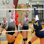 RYAN SPARKS | THE DAILY WORLD Raymond seniors Caton Swogger (11) and Alia Enlow (10) defend a shot by Forks outside hitter Kyra Neel during during the Seagulls 3-2 victory on Tuesday at Raymond High School.