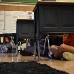 Clayton Franke | The Daily World 
Liz Newman (left), fifth grade teacher at Pacific Beach Elementary, watches over her students as they participate in the shelter in place portion of Thursdays earthquake and tsunami preparedness drill.