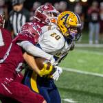 PHOTO BY ERIC TRENT Aberdeen running back Jeremy Sawyer (20) drags a WF West defender during the Bobcats 42-15 loss on Thursday in South Bend.