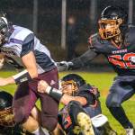 JARED WENZELBURGER | THE CHRONICLE
Tigers swarm and make a tackle after blocking a punt during a league championship game against Raymond-South Bend Friday night.