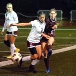 RYAN SPARKS | THE DAILY WORLD Montesano midfielder Belle Estrada, right, passes the ball while defended by WF Wests Daisy Medel (3) during the Bulldogs 4-3 win on Tuesday in Montesano. Estrada scored two second-half goals in the game.