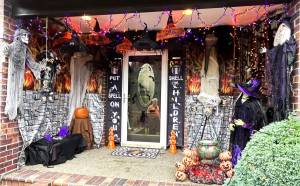 Matthew N. Wells / The Daily World
Dennis Bemis can be seen in the reflection of the front door to his home in the 1000 block of Fairway Drive in Central Park, which is also the location where ghouls, goblins, Jack-O-Lanterns and witches greet his family, friends and neighbors. While Bemis has had a tough year in 2022, describing the work and what went into getting he and his wife Michelles decorations set up seemed to lift his spirits during the late afternoon on Wednesday.