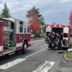 Michael S. Lockett / The Daily World 
Firefighters strip off their gear after responding to a residential structure fire in Hoquiam on Thursday.