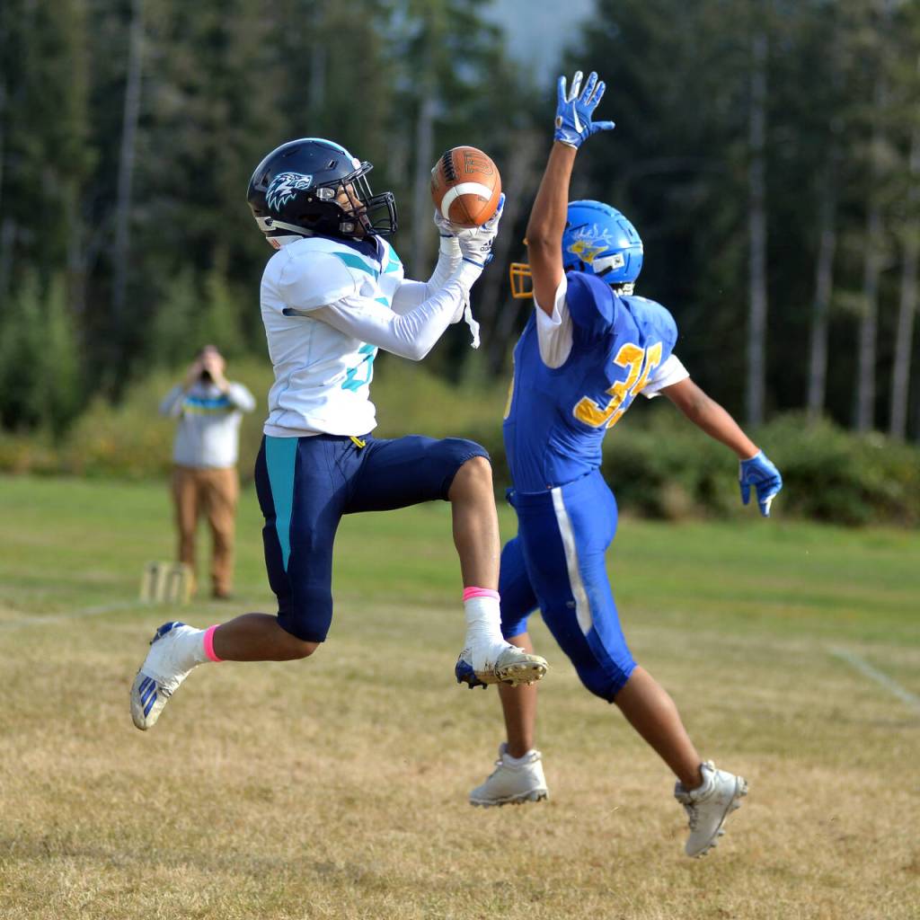 RYAN SPARKS | THE DAILY WORLD Lake Quinault defensive back Charles Gumecindo, right, defense a pass to Northwest Christian receiver Ryddis Robinson during a 67-38 win over Northwest Christian on Saturday, Oct. 29, 2022 at Lake Quinault High School.