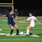 RYAN SPARKS | THE DAILY WORLD Aberdeen forward Maddi Gore (11) and RA Longs Madison Fierst compete for the ball during the Bobcats 1-0 loss in a 2A District 4 Tournament game on Saturday in Aberdeen.