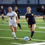 RYAN SPARKS | THE DAILY WORLD Aberdeen midfielder Zoe Troeh (12) dribbles away from RA Longs Alice Anderson during the Bobcats 1-0 loss in a 2A District 4 Tournament game on Saturday in Aberdeen.