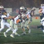 RYAN SPARKS / THE DAILY WORLD 
Montesano running back Bode Poler, middle, tries to break away from the tackle attempt of Seton Catholic linebacker Jacob Williams (4) during the Bulldogs 47-7 win over Seton Catholic in a 1A district crossover game on Friday, Nov. 4, in Montesano