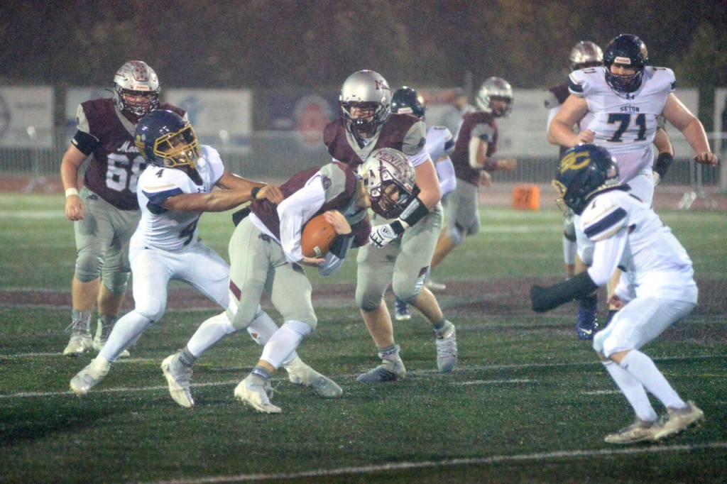 RYAN SPARKS / THE DAILY WORLD 
Montesano running back Bode Poler, middle, tries to break away from the tackle attempt of Seton Catholic linebacker Jacob Williams (4) during the Bulldogs 47-7 win over Seton Catholic in a 1A district crossover game on Friday, Nov. 4, in Montesano