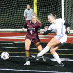 RYAN SPARKS / THE DAILY WORLD 
Elma forward Miley Seaberg (9) passes the ball while Montesanos Addi Kersker defends during the 1A District 4 Championship game on Saturday, Nov. 5, in Tenino.