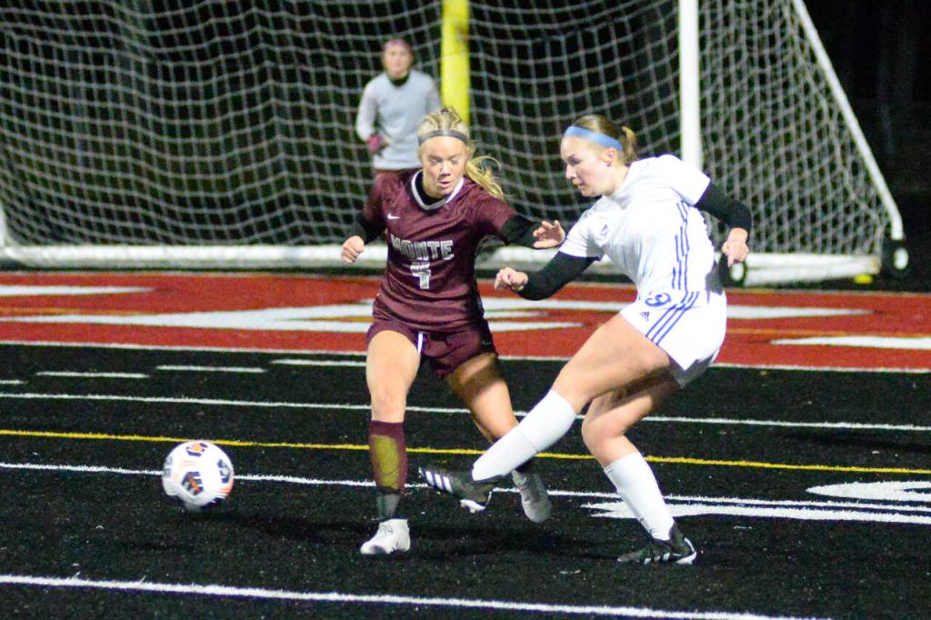 RYAN SPARKS / THE DAILY WORLD 
Elma forward Miley Seaberg (9) passes the ball while Montesanos Addi Kersker defends during the 1A District 4 Championship game on Saturday, Nov. 5, in Tenino.