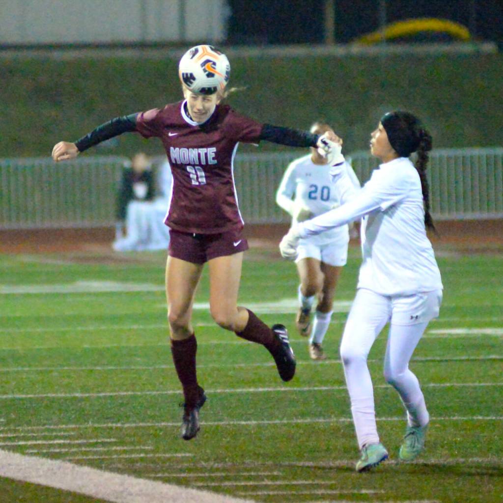 RYAN SPARKS / THE DAILY WORLD 
Montesano senior Lilly Causey (11) heads the ball while La Salles Brooke Gaytan during the Bulldogs 3-1 victory in a 1A State first-round playoff game on Wednesday at Jack Rottle Field in Montesano.