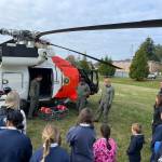 Michael S. Lockett / The Daily World 
Students from St. Mary School talk to the aircrew of an MH-60 Jayhawk from Coast Guard Air Station Astoria that visited Aberdeen as part of a Veterans Day ceremony on Nov. 10.