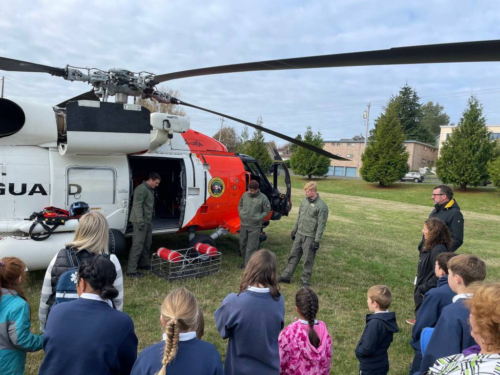 Michael S. Lockett / The Daily World 
Students from St. Mary School talk to the aircrew of an MH-60 Jayhawk from Coast Guard Air Station Astoria that visited Aberdeen as part of a Veterans Day ceremony on Nov. 10.