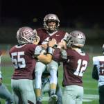 RYAN SPARKS / THE DAILY WORLD 
Montesano defensive back Bode Poler, middle, is congratulated by teammates Peyton Damasiewicz (55) and Cole Ekerson (12) after an interception in the second half of the Bulldogs 24-22 state-tournament win over Toppenish on Friday in Montesano.