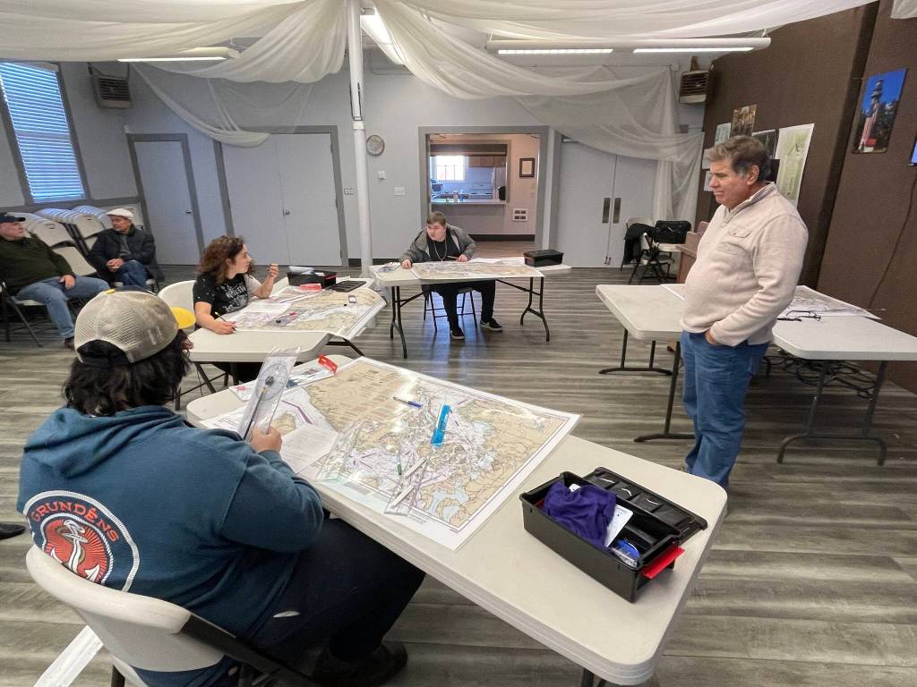 Students, instructed by Paul Mirante, right, work on a navigation exercise as part of the Ocosta High Schools Maritime afterschool program on Nov. 9. (Michael S. Lockett / The Daily World)