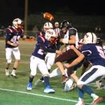 RYAN SPARKS | THE DAILY WORLD Derek Fluke (24) and the Pe Ell-Willapa Valley defense knocks the ball loose from Raymond-South Bend quarterback Austin Snodgrass during the Titans 34-13 win in a 2B State quarterfinal game on Friday in Montesano.