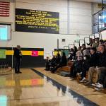 Former North Beach High School students gathered at the school Saturday to share memories of former principal Mike Duffy, who passed away last month. Duffy's picture is displayed on the projector. (Clayton Franke / The Daily World)