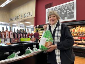 Matthew N. Wells / The Daily World
Ann Galland, owner of Montesanos Pick-Rite Thriftway  holds a large Jennie-O frozen turkey after explaining a few of the challenges grocery stores like hers run into at the holidays and throughout the year.