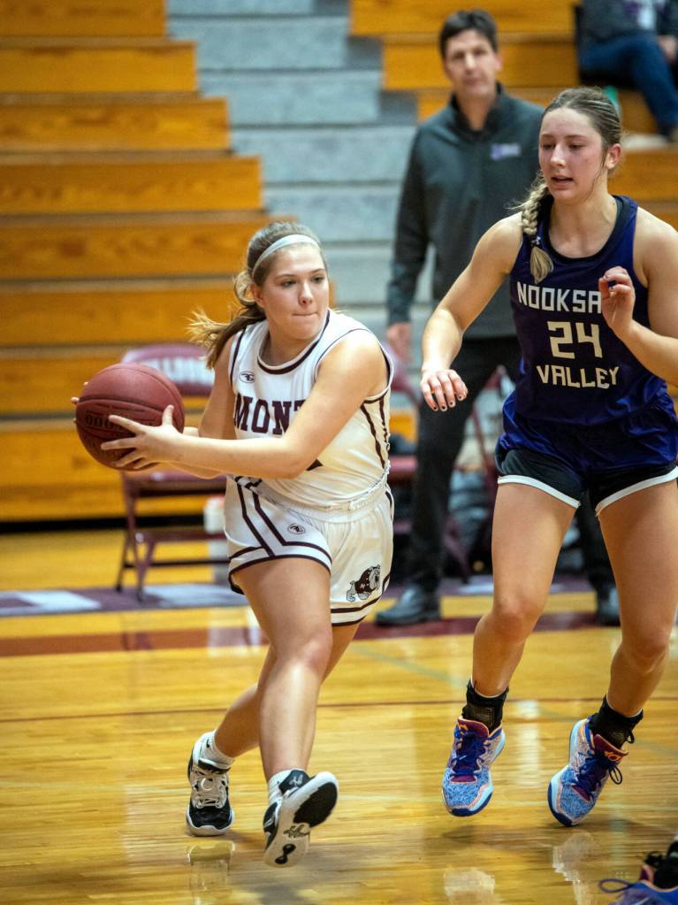 PHOTO BY FOREST WORGUM Montesanos Jordan Karr, left, looks to pass while being defended by Nooksack Valleys Devin Coppinger (24) during the Bulldogs 73-46 loss on Saturday in Montesano.