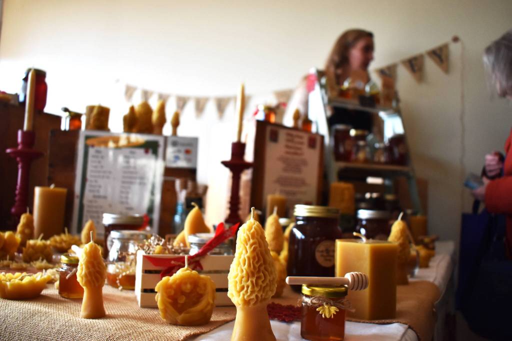 Clayton Franke / The Daily World 
Holly Houston tends to her booth at Saturdays holiday market, which was a part of WinterFest 2022. Her business, Honey Glow Harvest, sells an array of products, all crafted from either beeswax or honey.Houston said events like WinterFest are helpful for her business during non-tourist seasons.