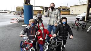 In a past year, the Delimonts  Joseph, 8, Eliot, 6, and Jarom, 9, show off their new bikes they got from Bicycles from Heaven, with their parents Kina and David (from left.)