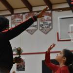 Evie Wentworth, Taholah Chitwins middle school girls basketball team manager, reaches to high-five Ruthie Bolton Wednesday night. (Clayton Franke / The Daily World)