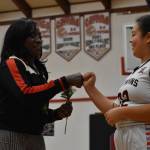 Luvaila Smith, right, a player on the Taholah Chitwins middle school basketball team, embraces Ruthie Bolton during halftime of the contest the Chitwins would go on to win. (Clayton Franke / The Daily World)
