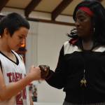 Jacob Krise, player for the Taholah Chitwins middle school boys basketball team, embraces Ruthie Bolton before the team's game Wednesday evening. (Clayton Franke / The Daily World)