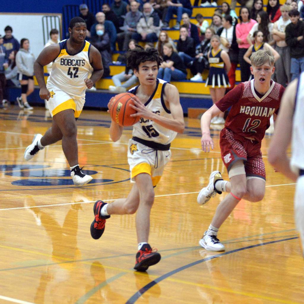 RYAN SPARKS | THE DAILY WORLD Aberdeen guard Issac Garcia (15) drives while shadowed by Hoquiams Michael Lorton Watkins during the Grizzlies 66-47 win on Monday at Sam Benn Gym in Aberdeen.
