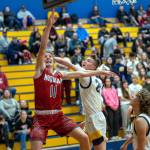 PHOTO BY FOREST WORGUM Hoquiams Zander Jump (11) scores two of his game-high 24 points while defended by Aberdeens Baylor Ainsworth in the Grizzlies 66-47 win on Monday at Sam Benn Gym in Aberdeen.