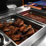 Matthew N. Wells / The Daily World 
Two of Big Moons smoked specialties  chicken and ribs  lead customers to the order counter, where they meet the friendly staff who helps them get their order right. Brisket and pulled pork are two of the other specialties Kevin Mooney, the restaurants owner, serves his customers. The sides  macaroni and cheese, beans and cole slaw  are also homemade.