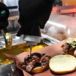 Matthew N. Wells / The Daily World 
Kevin Mooney, owner of Big Moons BBQ and Southern Cuisine, dials up a well-reviewed pulled pork sandwich with cole slaw and barbecue sauce. In front of the sandwich lies his homemade macaroni and cheese.